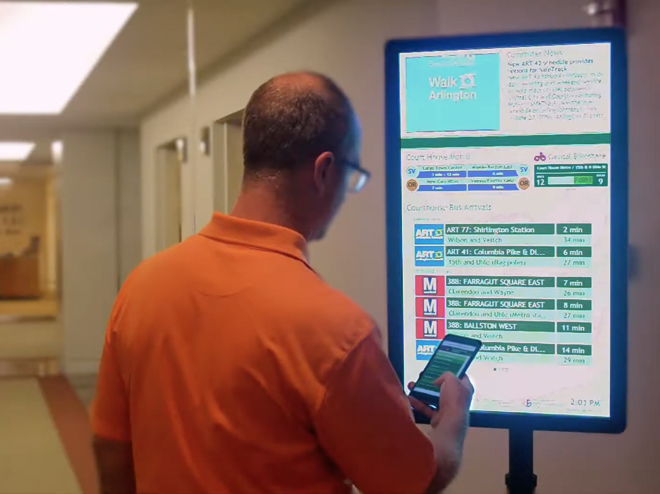 Image of one of our team members demonstrating what we do with transit displays
