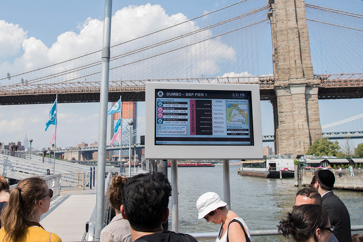 Image of people looking at our Transit Display at NYC Ferry